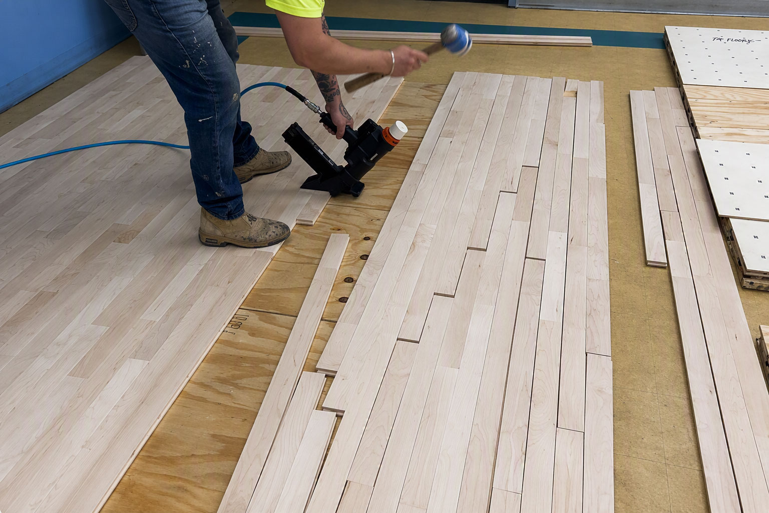 Installer assembling an L-Evate™ Rhythm sprung dance flooring system